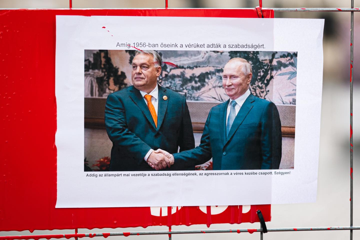 In Budapest, opposition parliamentarians splashed red paint on Orban's office